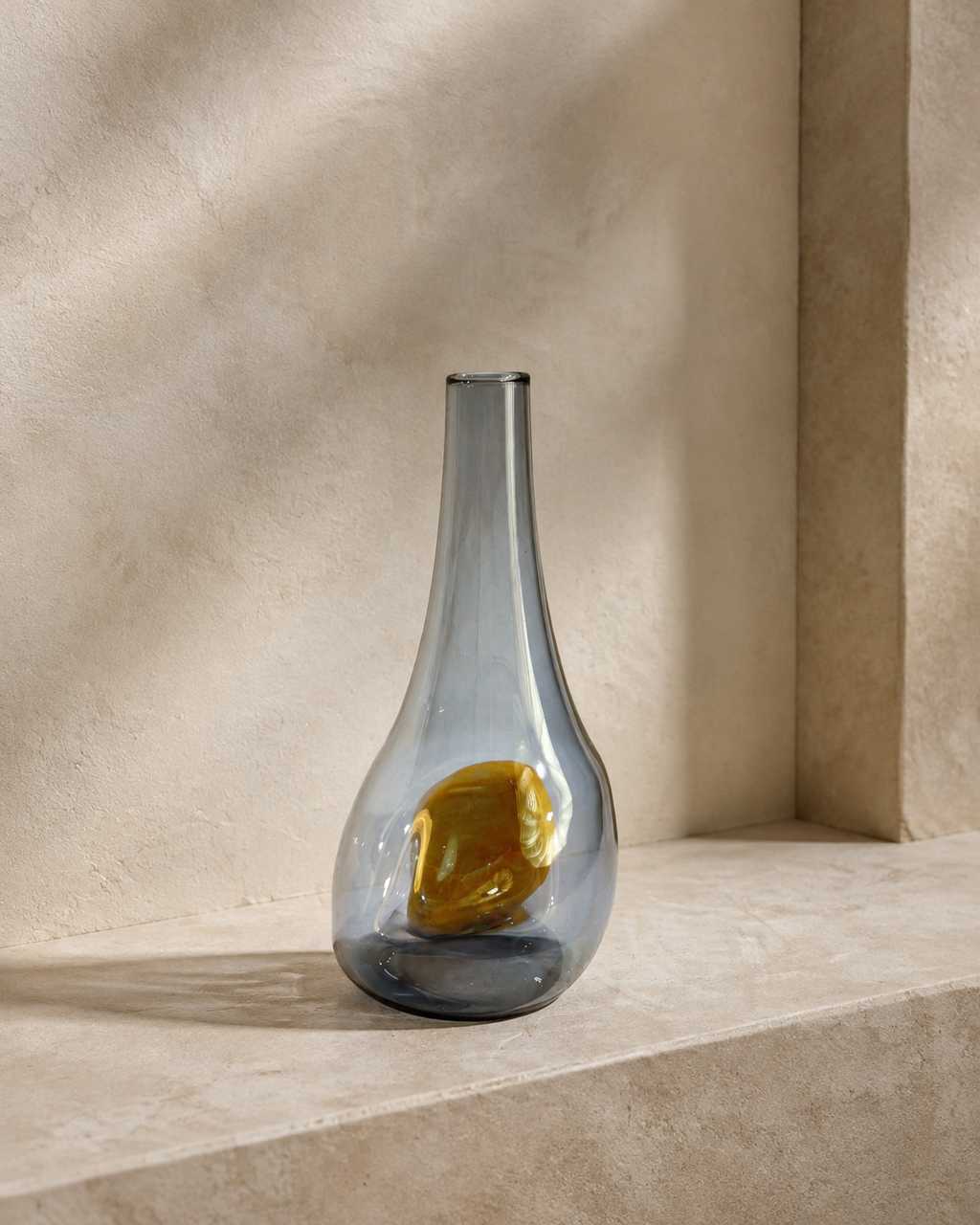 Alternate view of Stoneveil No. 007 gray-blue glass vase paired with a rounded golden stone