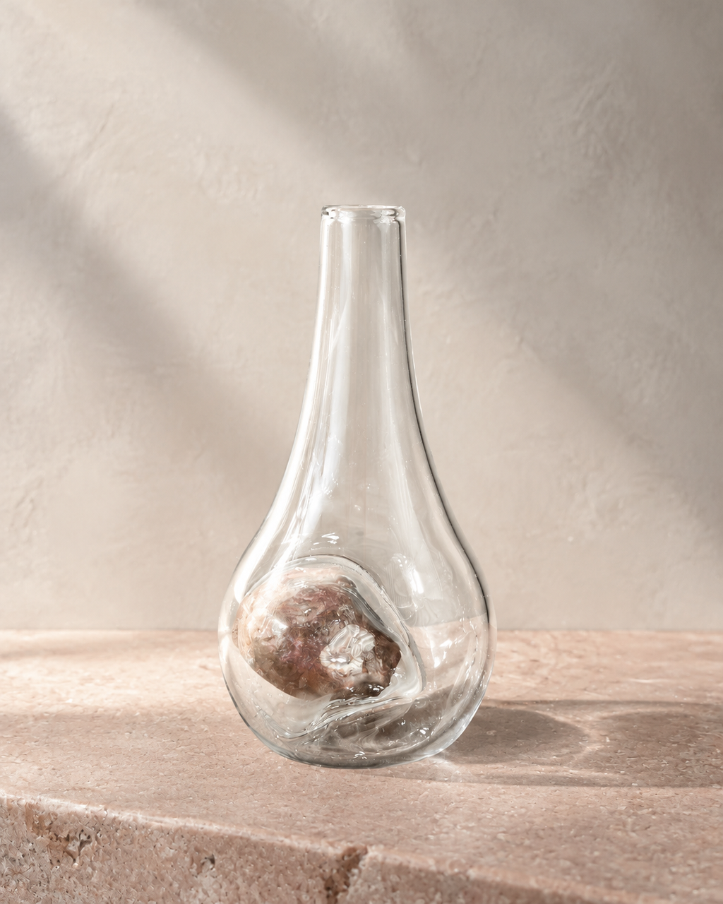 Alternate view of Stoneveil No. 006 clear glass vase paired with a mottled mauve natural stone