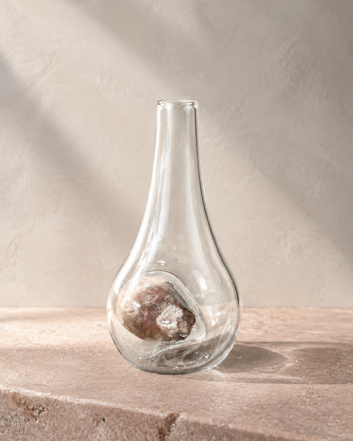 Alternate view of Stoneveil No. 006 clear glass vase paired with a mottled mauve natural stone