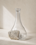 Stoneveil No. 002 sculptural clear glass vase displayed empty on warm ivory