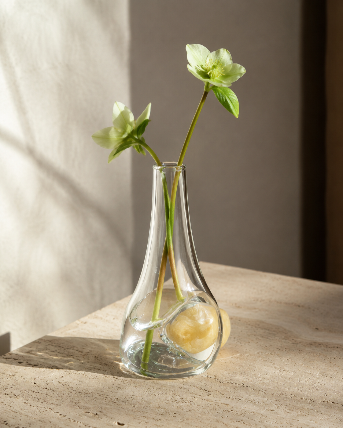 Stoneveil No. 005 clear glass and ivory stone bud vase styled with green hellebores