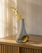 Stoneveil No. 007 smoke-blue glass and golden stone bud vase styled with yellow oncidium