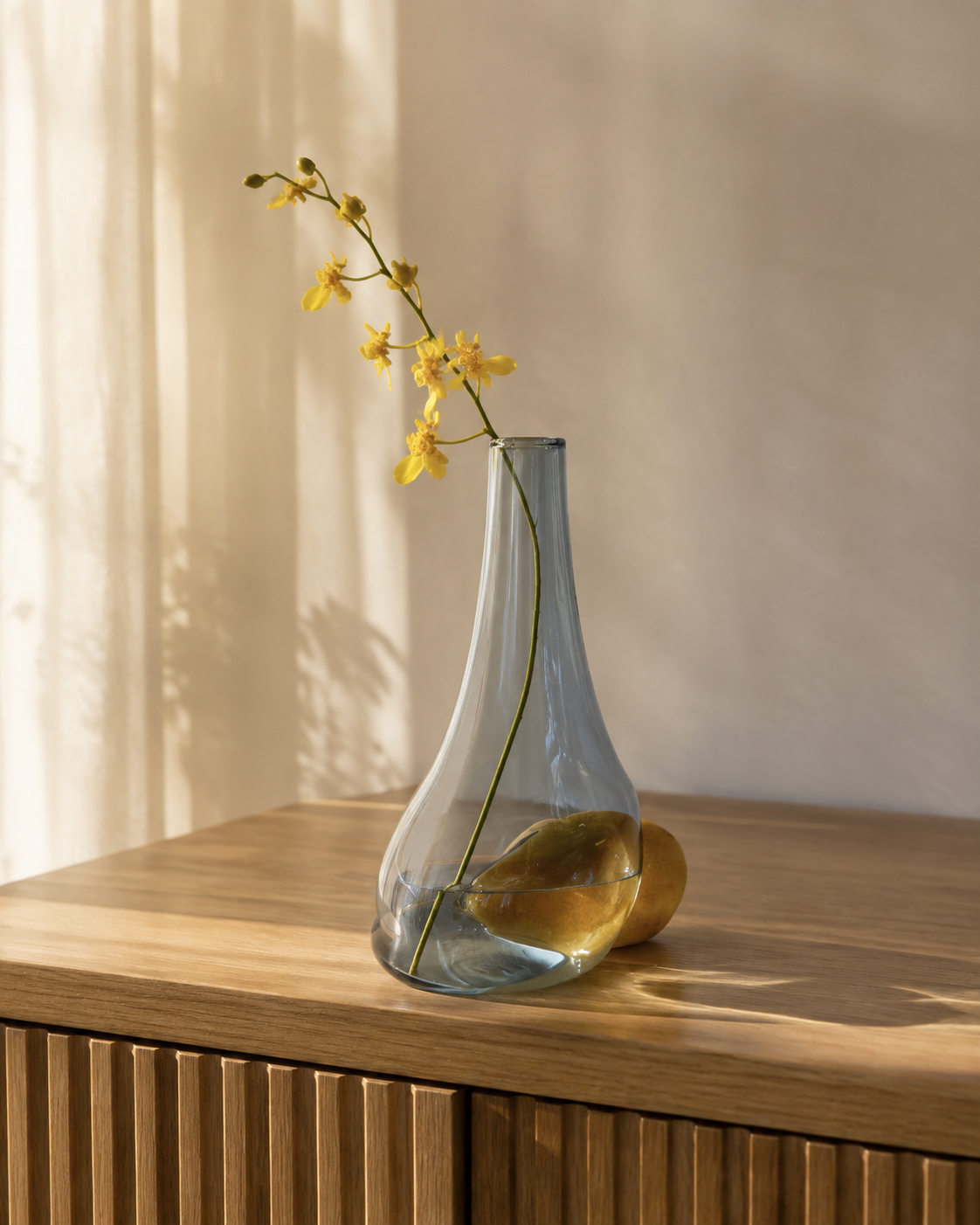 Stoneveil No. 007 smoke-blue glass and golden stone bud vase styled with yellow oncidium