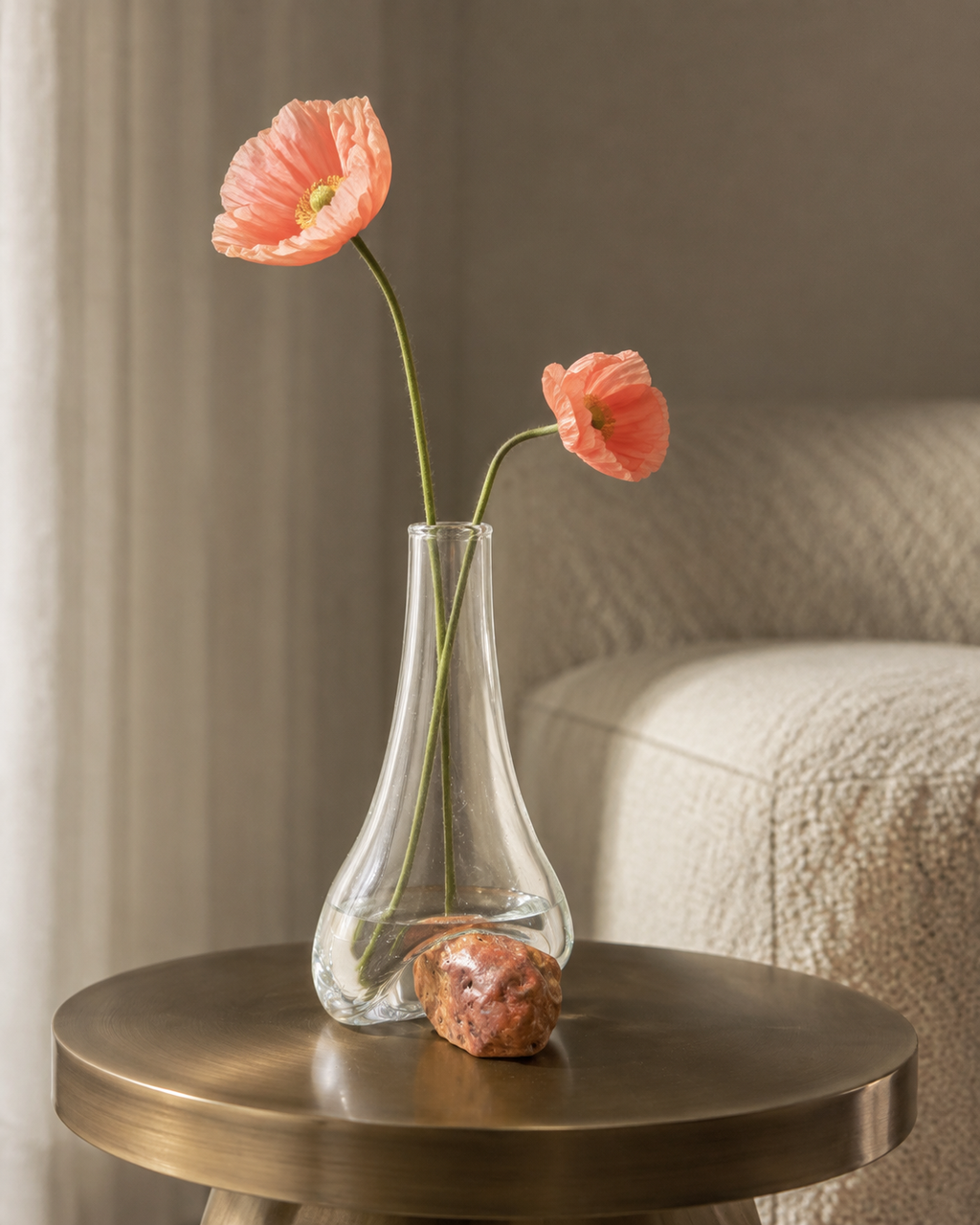Stoneveil No. 004 sculptural bud vase with salmon poppies on a bronze side table