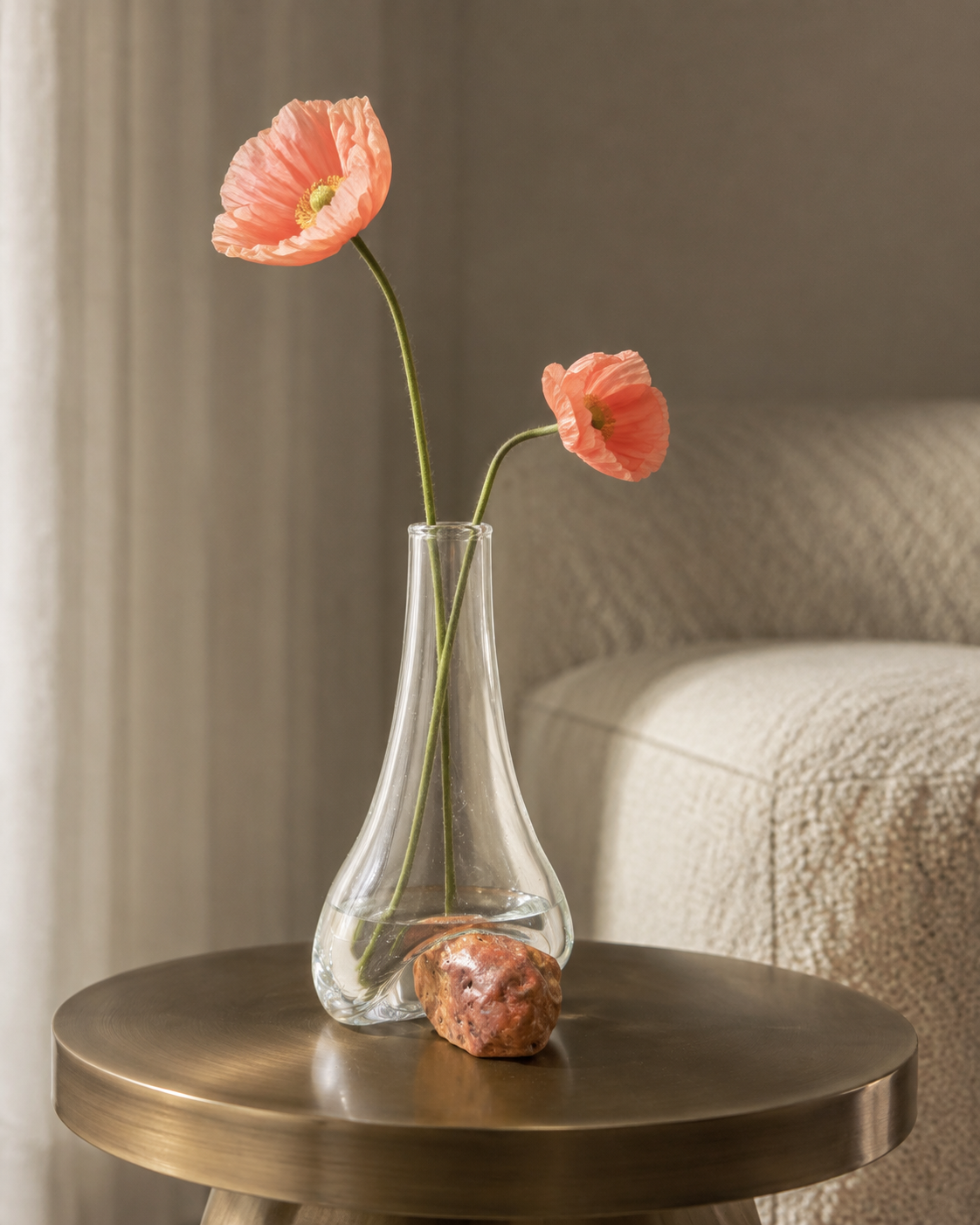 Stoneveil No. 004 sculptural bud vase with salmon poppies on a bronze side table