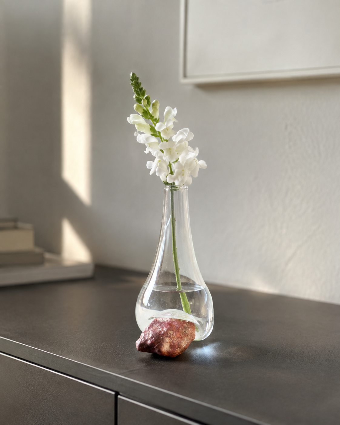 Stoneveil No. 006 clear glass and mauve stone vase with a white snapdragon