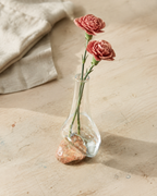 High-angle view of Stoneveil No. 004 styled with dusty rose carnations on an atelier table