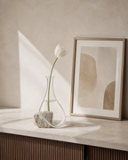 Stoneveil No. 002 styled with an ivory tulip on a warm home console