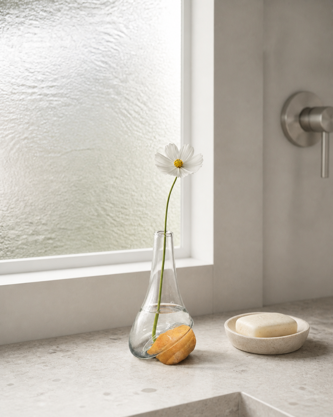 Stoneveil No. 001 styled with a white cosmos on a pale terrazzo vanity