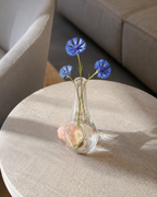 Stoneveil No. 004 small clear glass vase styled with blue cornflowers in a hotel lounge