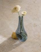 Stoneveil No. 007 gray-blue glass vase styled with cream chrysanthemums on a limestone tea table