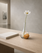 Stoneveil No. 001 with a white cosmos on a contemporary gallery reception desk